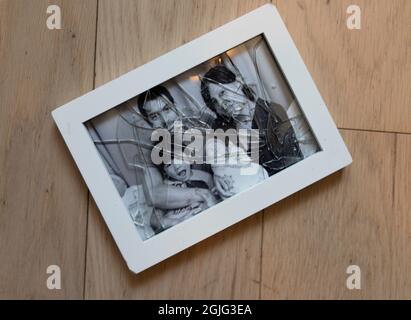 family of four in broken frame Stock Photo