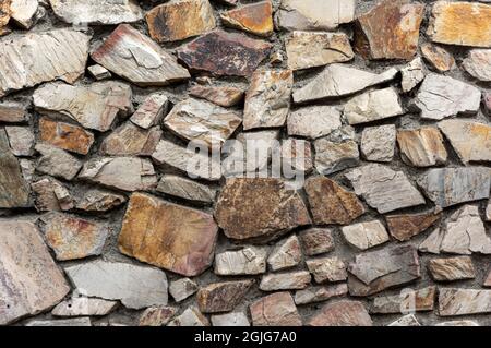 Grey wall with inlaid stones Stock Photo