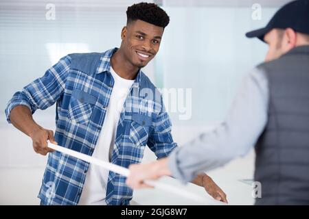two men fitting a kitchen Stock Photo