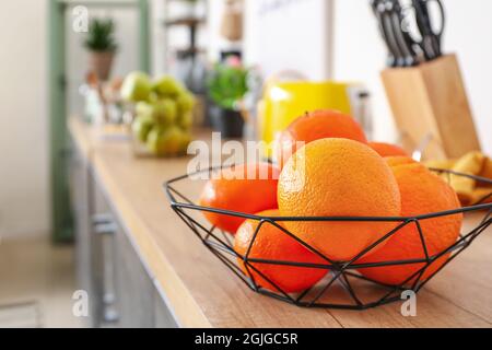 Basket with fresh fruits on counter in kitchen, closeup Stock Photo