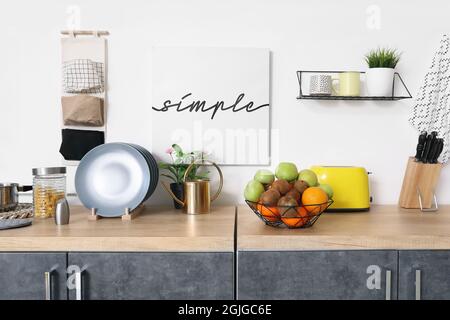 Basket with fresh fruits on counter in kitchen Stock Photo