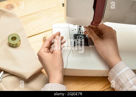 Female hands using wooden tailor ruler to measure cotton fabric. Textile  sale and sewing concept Stock Photo - Alamy