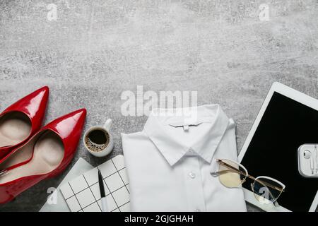 Stylish female clothes, accessories and modern gadgets on grey background Stock Photo