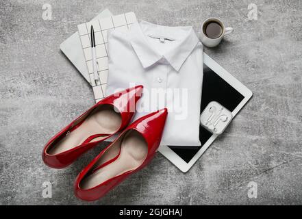Stylish female clothes, accessories and modern gadgets on grey background Stock Photo