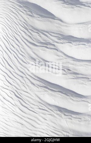 Textured effect of waves on surface of gray-white stone. Pamukkale travertine surface in Turkey. Stock Photo