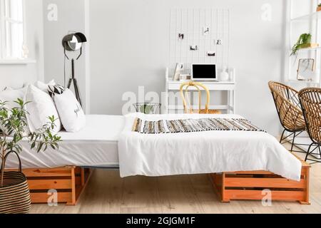 Interior of stylish room with comfortable bed Stock Photo