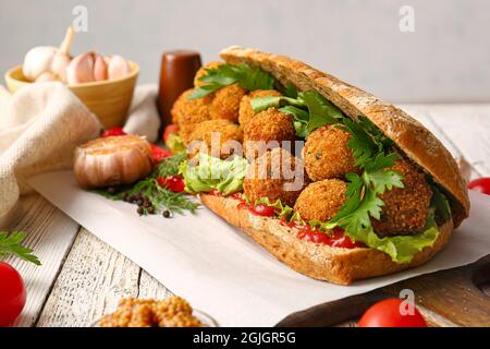 Board with bread and tasty cod cutlets on table, closeup Stock Photo