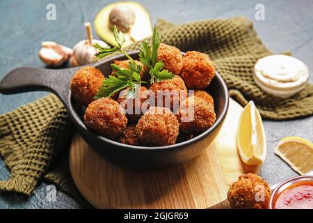 Frying pan with tasty cod cutlets on dark background, closeup Stock Photo