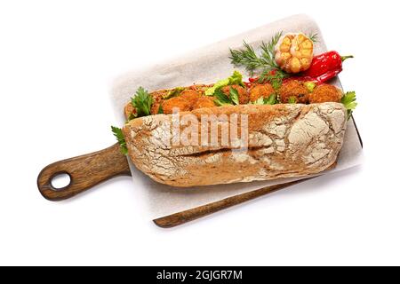 Board with bread and tasty cod cutlets on white background Stock Photo