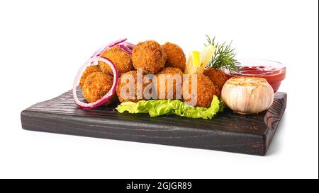 Board with tasty cod cutlets and sauce on white background Stock Photo