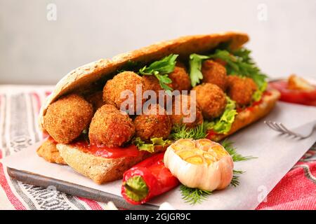 Board with bread and tasty cod cutlets on table, closeup Stock Photo