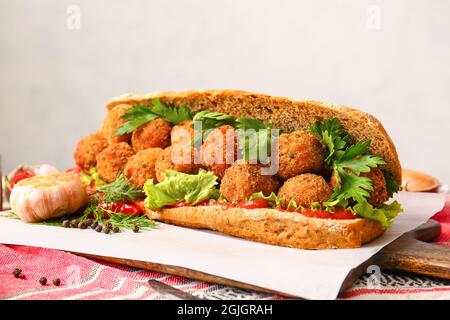 Board with bread and tasty cod cutlets on table Stock Photo