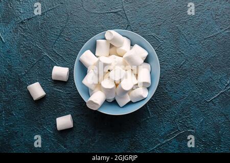Bowl with tasty marshmallows on dark background Stock Photo