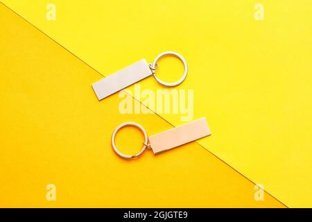 Stylish keychains on color background Stock Photo - Alamy