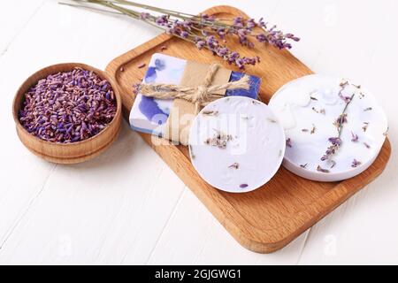 Composition with soap bars and lavender flowers on white wooden background Stock Photo