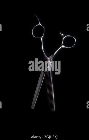 professional barber's hair cutting scissors on black background Stock Photo