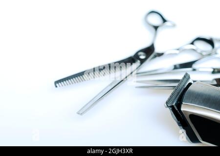 Professional barber's hair cutting tools set on white background. Stock Photo