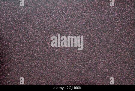 Monochrome dark burgundy background with a scattering of small silvery blotches. Background, pattern, texture. Stock Photo