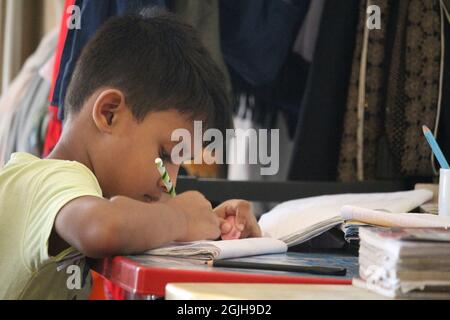 July 15, 2019, Savar, Dhaka, Bangladesh. The child is doing school homework Stock Photo