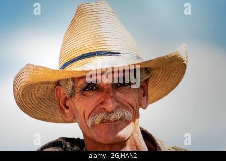 Portrait of farm worker wearing a straw cowboy hat on sugar plantation, Valle de los Ingenios, Trinidad, Cuba Stock Photo