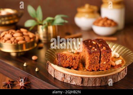 Carrot and dates Christmas cake made with dried fruit, raisins, cashew nuts, almond. Tasty home made cake flavored cinnamon , spices on Christmas new Stock Photo