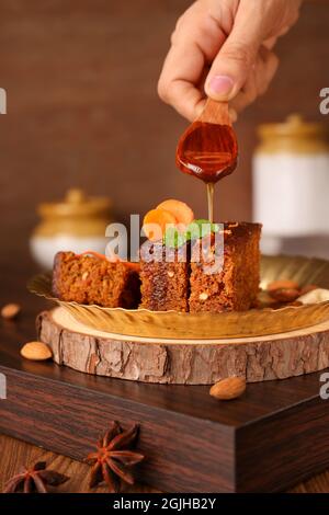 Carrot and dates Christmas cake made with dried fruit, raisins, cashew nuts, almond. Tasty home made cake flavored cinnamon , spices on Christmas new Stock Photo