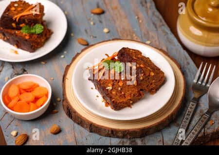 Carrot and dates Christmas cake made with dried fruit, raisins, cashew nuts, almond. Tasty home made cake flavored cinnamon , spices on Christmas new Stock Photo