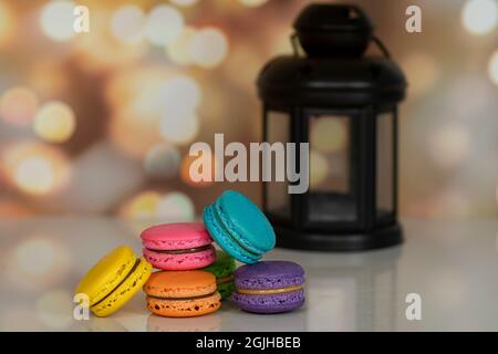 Delicious macaroons, a famous multicoloured French dessert in a pile. Selective focus. Blurred background Stock Photo
