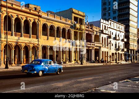 Old classic American car driving past colonial style buildings, Havana, Cuba Stock Photo