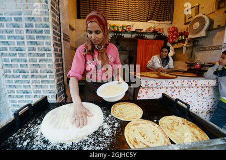 Moroccan women preparing traditional Moroccan bread in a small shop at the Salé medina, Morocco. Stock Photo