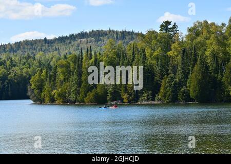 Two people are kayaking on Bass Lake on a sunny day in Ontario, Canada, North America. Stock Photo