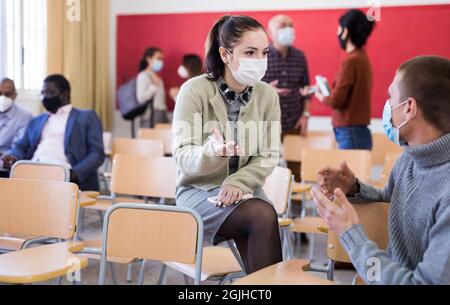 Students wearing protective mask in classroom Stock Photo
