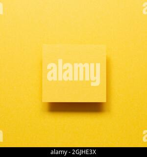 Blank memo paper on yellow background. top view, copy space Stock Photo