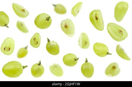 Falling green grape, isolated on white background, selective focus Stock Photo