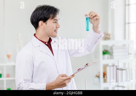 Scientists happy smile for successful discover  chemical formula develop to new drug in medical laboratory concept. Stock Photo