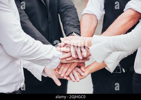 Closeup business people join hand together for unity teamwork group and diversity cooperation success team. Stock Photo