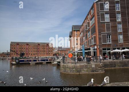 Views of Gloucester Quay with converted warehouses and restaurants full of diners. Stock Photo