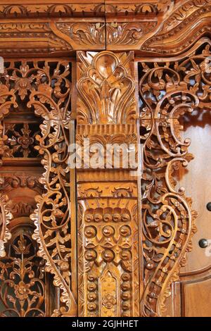 The pattern of carving wayang gunungan on the door of an Indonesian wooden house, with an artistic and classy traditional ethnic feel. Stock Photo