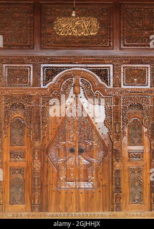 The pattern of carving wayang gunungan on the door of an Indonesian wooden house, with an artistic and classy traditional ethnic feel. Stock Photo