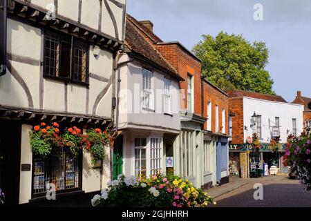 Traditional buildings with flowers in pretty Church Street, Godalming on the River Wey, Surrey, England Stock Photo