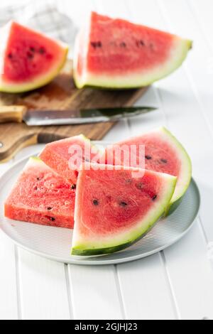 Red sliced watermelon. Pieces of red melon on plate. Stock Photo