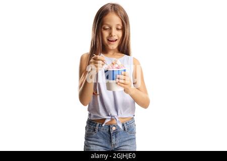 Excited cute girl holding ice cream in a paper cup isolated on white background Stock Photo