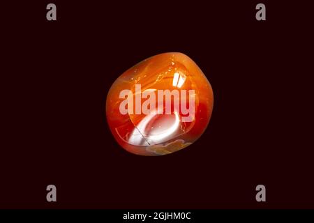 Carnelian agate gemstone isolated on a black background Stock Photo