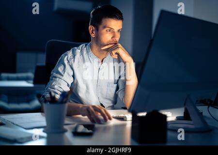 Business Analyst Businessman Working Late On Computer In Office Stock Photo
