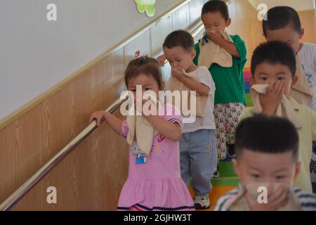 Handan, Handan, China. 10th Sep, 2021. On September 10, 2021, the children of Zhangzhuangqiao Experimental Kindergarten in Handan City, Hebei Province conducted earthquake-proof drills at the theme education activity of ''World First Aid Day''.The second Saturday in September every year is ''World First Aid Day''. Zhangzhuangqiao Experimental Kindergarten in Hanshan District, Handan City, Hebei Province launches first aid day theme education activities, organizing teachers and students to conduct daily rescue learning, disaster prevention and avoidance drills, etc. Credit: ZUMA Press, Inc./Ala Stock Photo