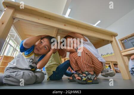 Handan, Handan, China. 10th Sep, 2021. On September 10, 2021, the children of Zhangzhuangqiao Experimental Kindergarten in Handan City, Hebei Province conducted earthquake-proof drills at the theme education activity of ''World First Aid Day''.The second Saturday in September every year is ''World First Aid Day''. Zhangzhuangqiao Experimental Kindergarten in Hanshan District, Handan City, Hebei Province launches first aid day theme education activities, organizing teachers and students to conduct daily rescue learning, disaster prevention and avoidance drills, etc. Credit: ZUMA Press, Inc./Ala Stock Photo