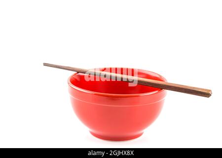 Fresh red bowl with chopsticks isolated on white background Stock Photo