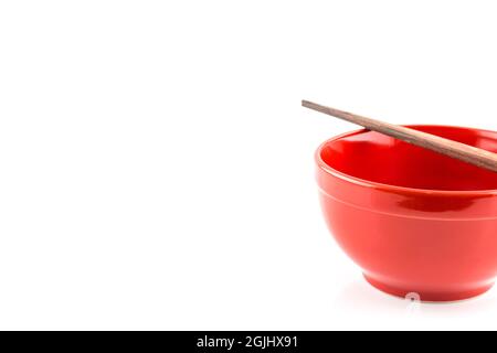 Fresh red bowl with chopsticks isolated on white background Stock Photo