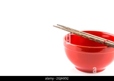 Fresh red bowl with chopsticks isolated on white background Stock Photo