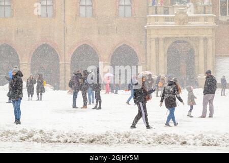 Bologna, Italy. 01st Mar, 2018. A tourist walk in Piazza Maggiore covered with snow. The 'Beast from the East', an unusually cold and snowy weather, s Stock Photo